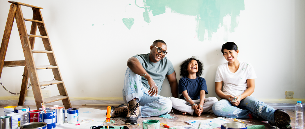 family sitting on floor with renovation items