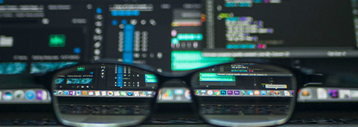 blurry view of coded screen made clear with a pair of glasses