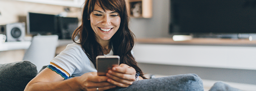 woman sitting on couch on phone
